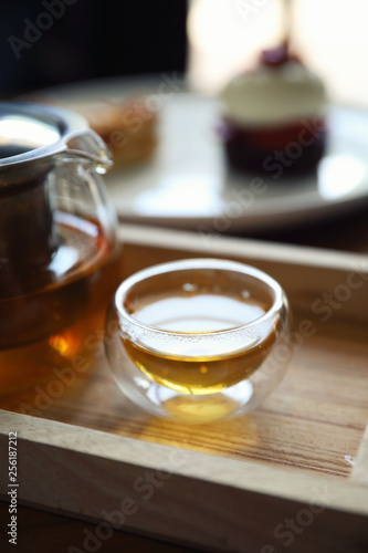 Hot teacup with teapot beverage on wooden table