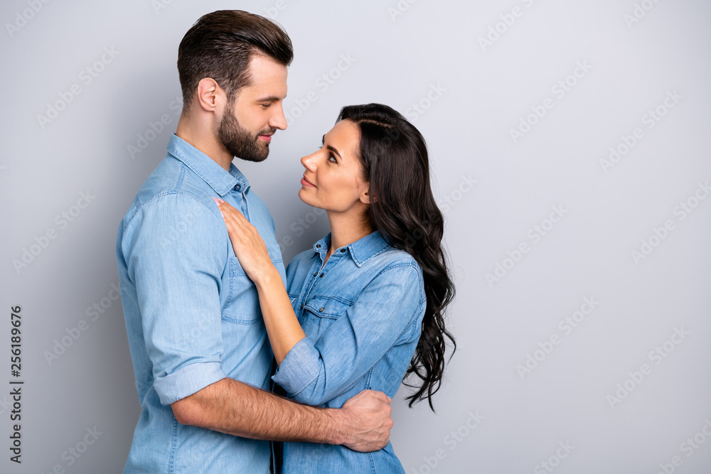 Profile side view photo of charming handsome affectionate casual spouses married delighted dressed in blue denim clothing isolated on grey background Profile side view photo of charming handsome affectionate casual spouses married delighted dressed in blue denim clothing isolated on grey background
