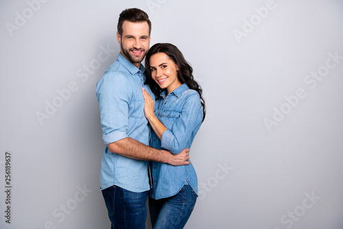 Portraite of attractive beatiful soulmates showing their passion satisfied wearing denim shirts isolated on silver background