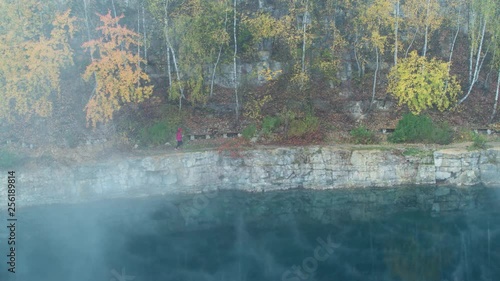 Wallpaper Mural Aerial drone shot of girl running early in the morning near lake with amazing blue water and mist fog Torontodigital.ca