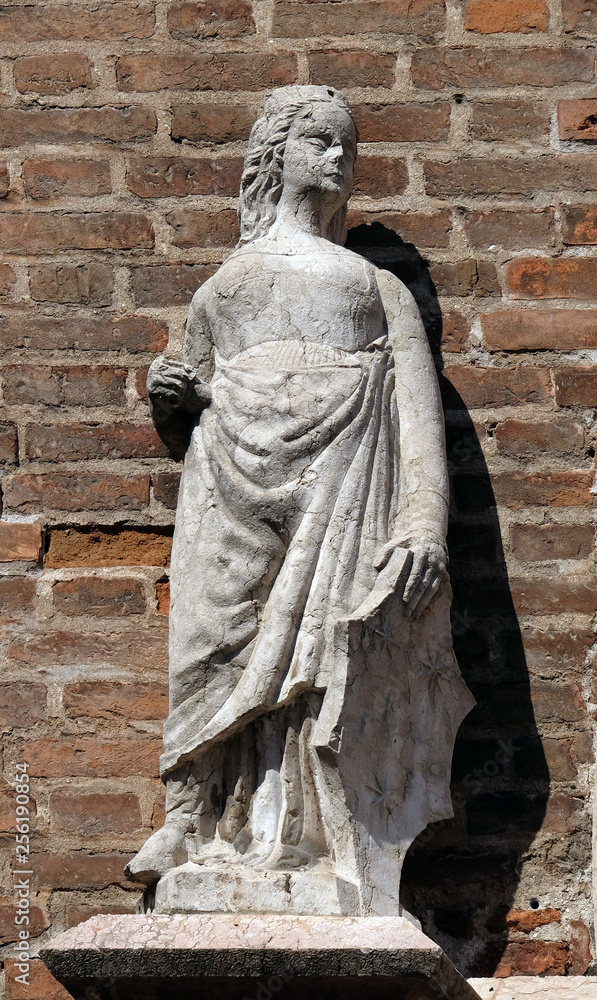 Female statue on the portal of Saint Eufemia Gothic-style, Roman Catholic church in Verona, Italy Female statue on the portal of Saint Eufemia Gothic-style, Roman Catholic church in Verona, Italy