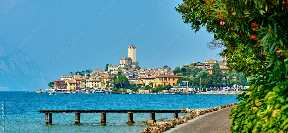 View of the beautiful Lake Garda in Veneto region, Malcesine town and old castle on rock in the summer time , Italy