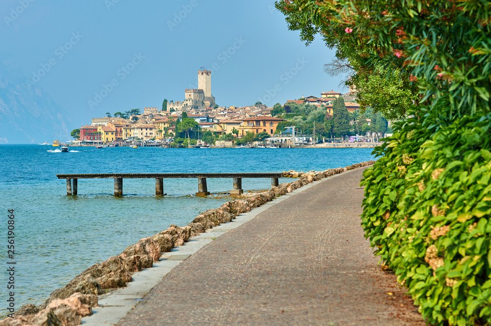 View of the beautiful Lake Garda in Veneto region, Malcesine town and old castle on rock in the summer time , Italy