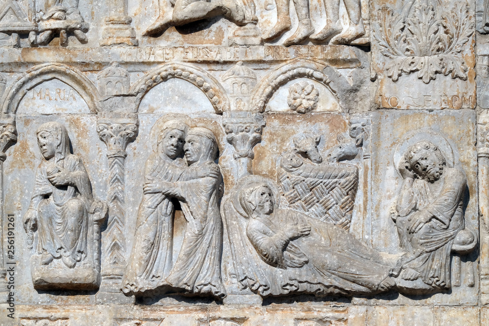 Annunciation, Visitation and Birth of Jesus, medieval relief on the facade of Basilica of San Zeno in Verona, Italy