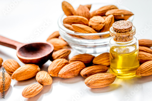 cosmetic set with almond oil on wooden table background