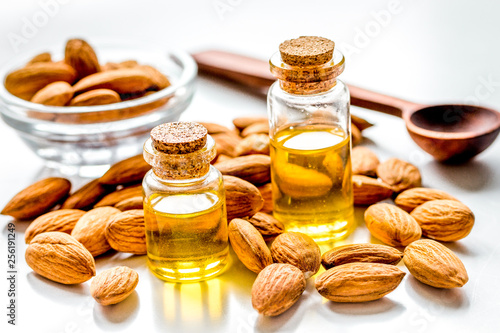 organic cosmetic with almond extract on table background