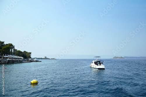 Boat in the Adriatic sea, Montenegro. Blue sky and calm water. Sunny summer day