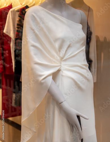 Mannequin with white dress on the shop window
