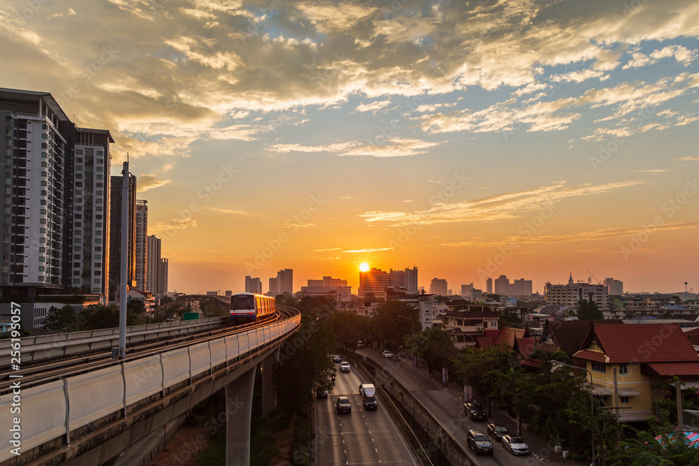 Cityscape of Bangkok city with low and hight building along the street with sky train on rail way.