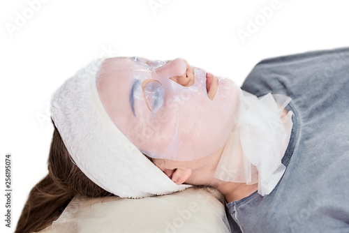 Cosmetic facial lifting mask. Treatment,  skin care procedure. Woman in a beauty salon
