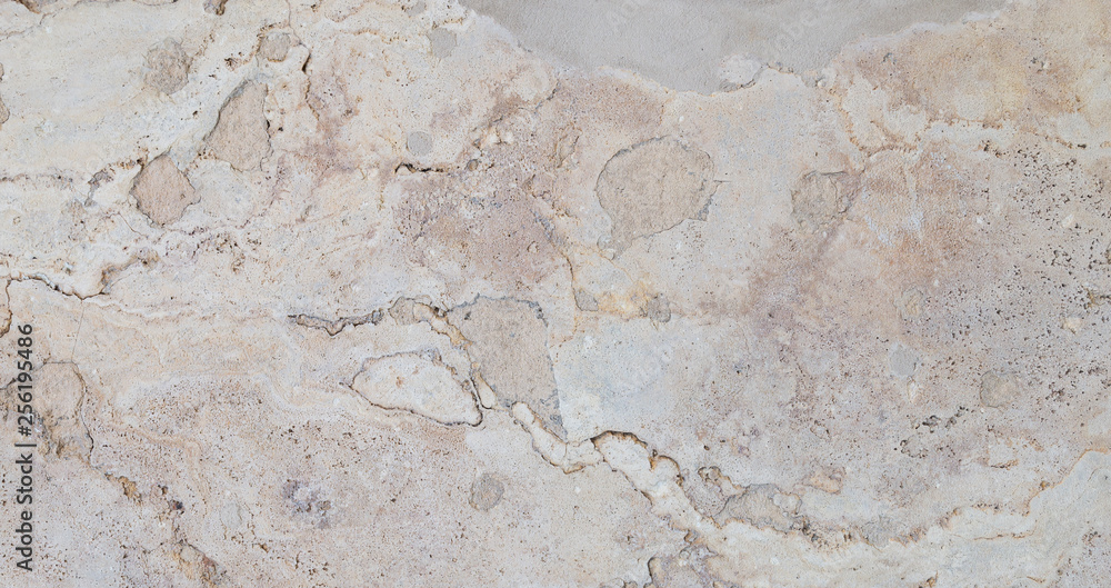 Full frame texture background of a weathered and abstract light brown stone slab. Full frame texture background of a weathered and abstract light brown stone slab.
