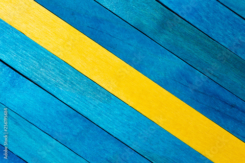 Aquamarine diagonal colored wooden background with yellow stripe