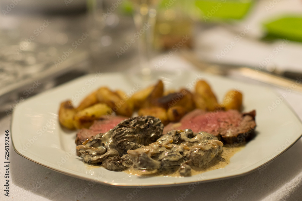 Beef tenderloin, morels and ratte potatoes for christmas diner. French speciality for festive Christmas celebration. Beef tenderloin, morels and ratte potatoes for christmas diner. French speciality for festive Christmas celebration.