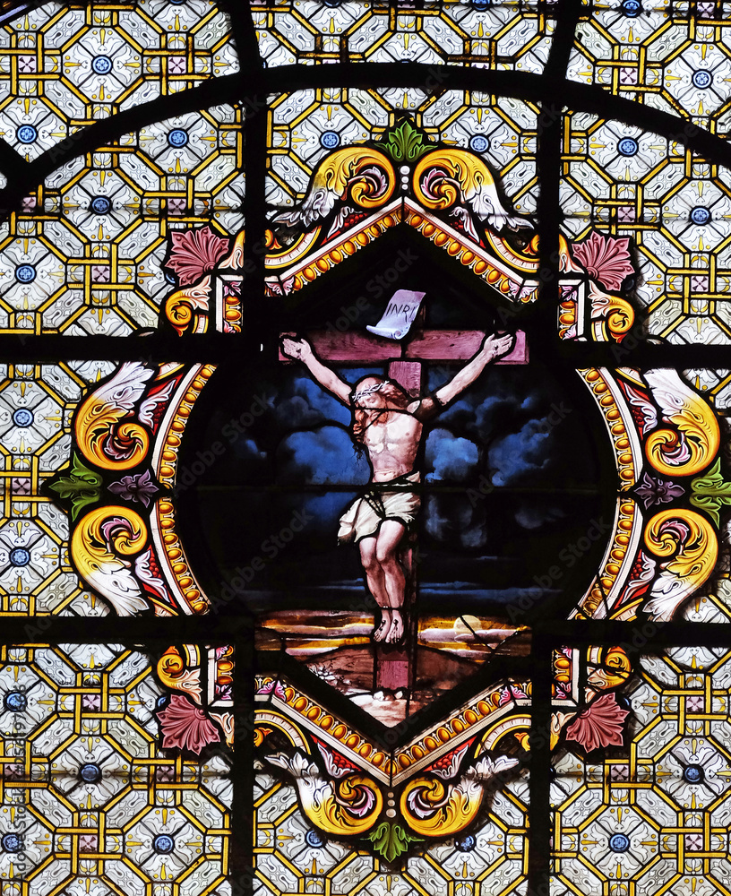 Jesus Christ on the cross, stained glass window in the Saint Sulpice Church, Paris, France