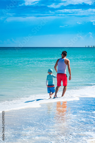 Padre e hijo disfrutando en una playa tropical © ismel leal