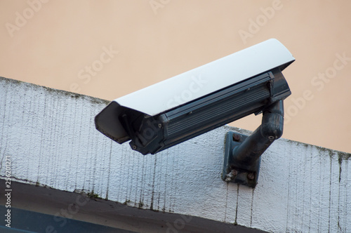 closeup of white security camera of security on urban background