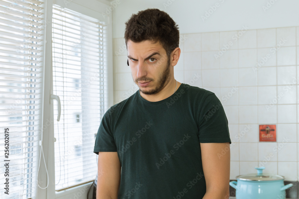 Young man looking at the camera in surprise. Young man looking at the camera in surprise.