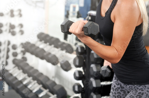 Sporty woman workout with dumbbell in gym