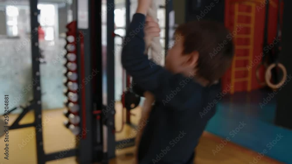 Father teaches son to climb rope Father teaches son to climb rope