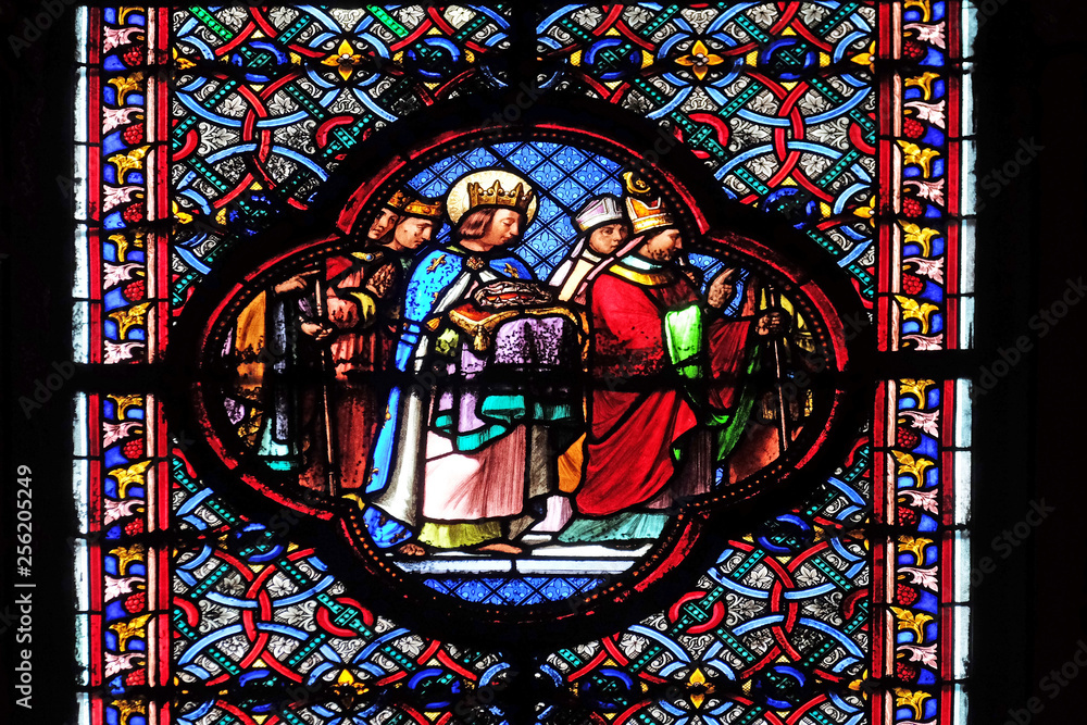 Saint Louis bringing the Crown of Thorns, stained glass window in the Basilica of Saint Clotilde in Paris, France 