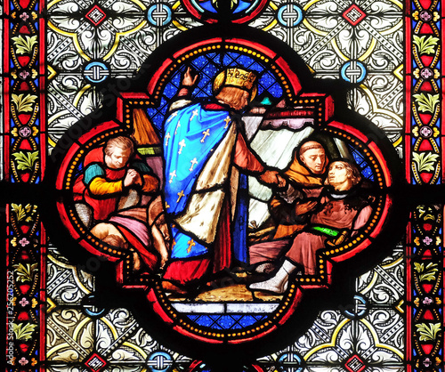 Saint Louis attending the plague victims, stained glass window in the Basilica of Saint Clotilde in Paris, France 