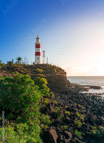 vertical picture of a lighthouse on a cliff during sunset in albion, mauritius photo