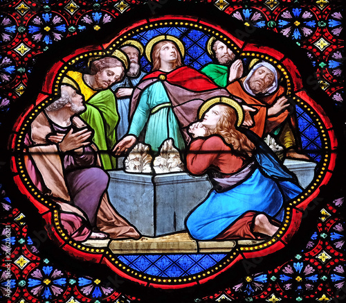Apostles before empty tomb of Virgin Mary, stained glass window in the Basilica of Saint Clotilde in Paris, France 