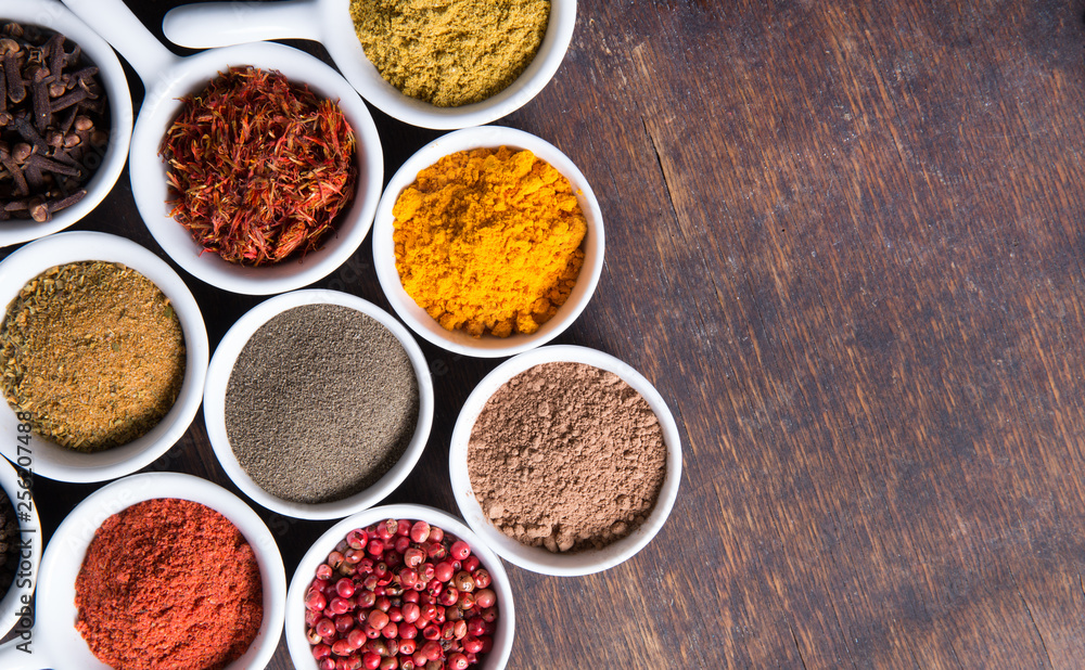 Herbs and spices in ceramic bowls. Aromatic ingredients and natural food additives. Herbs and spices in ceramic bowls. Aromatic ingredients and natural food additives.
