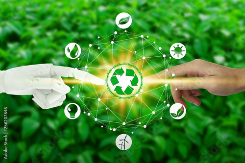 Robot and human hands with touching virtual environment icons over the network connection on nature background, Artificial Intelligence and Technology ecology concept.