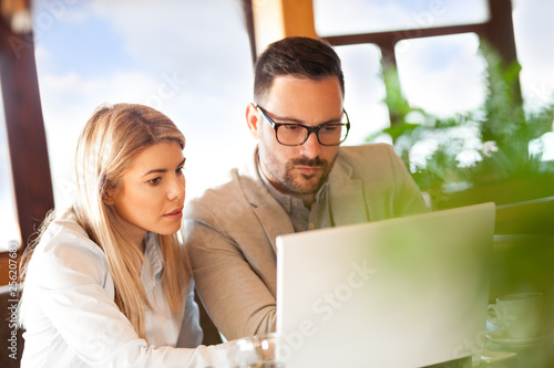 Colleagues discussing plans remember looking at laptop