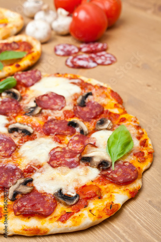 whole pepperoni and mushroom pizza with ingredients