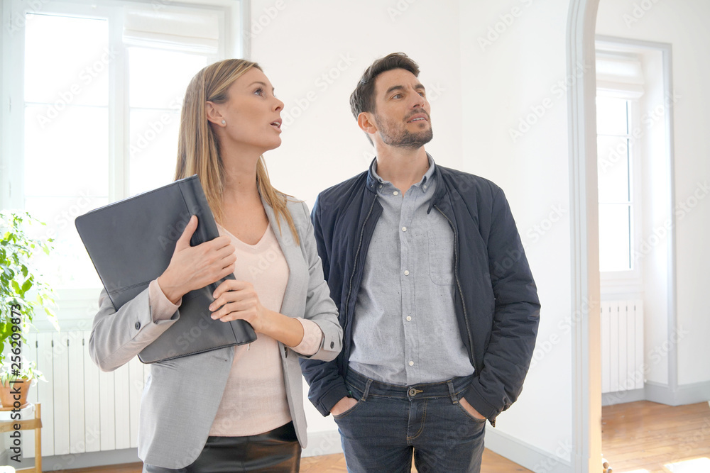 Real estate agent showing contemporary house for sale Real estate agent showing contemporary house for sale