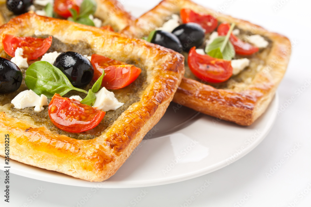 Mediterranean puff pastry with pesto, cherry tomatoes, olives and feta cheese
