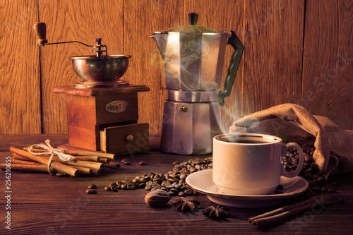 Coffee cup and coffee beans on a wooden table and wooden background
