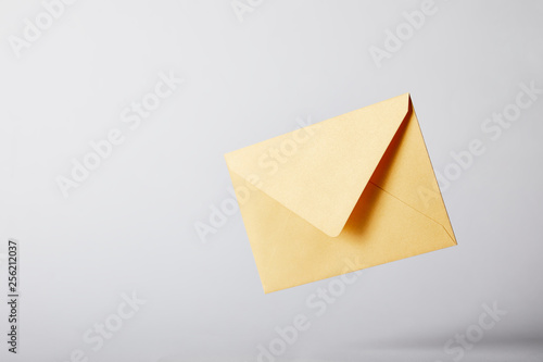 yellow and bright envelope on grey background with copy space