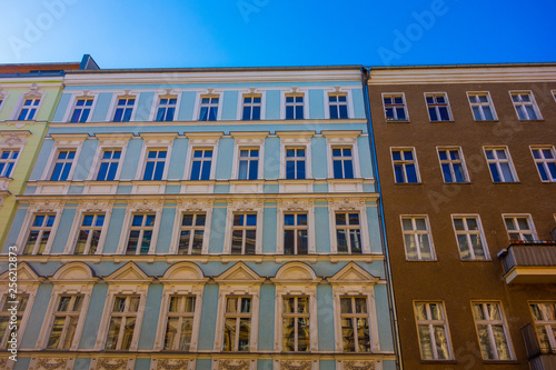 yellow, blue and brown houses in a row