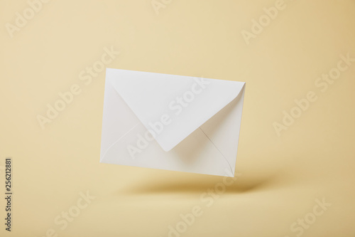 white and empty envelope on yellow background with copy space