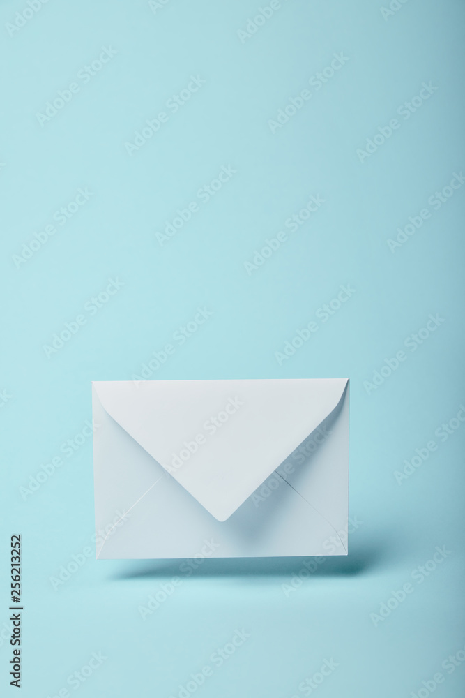 white and empty envelope on blue background with copy space white and empty envelope on blue background with copy space