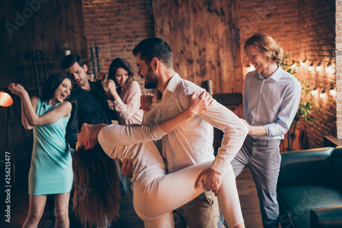 Close up photo classy best friends gathering hang out slow dance partners tango hold leg hip she her ladies hair volume flight he him his guys wear dress shirts formal wear sit sofa loft room indoors