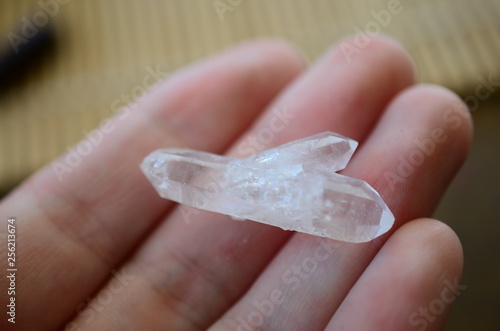 Clear Quartz points being held in woman's hand. Healing quartz points, bright colors. Healing crystals being held, reiki energy healing. Natural lighting photo with macro lens, photo of clear quartz.
