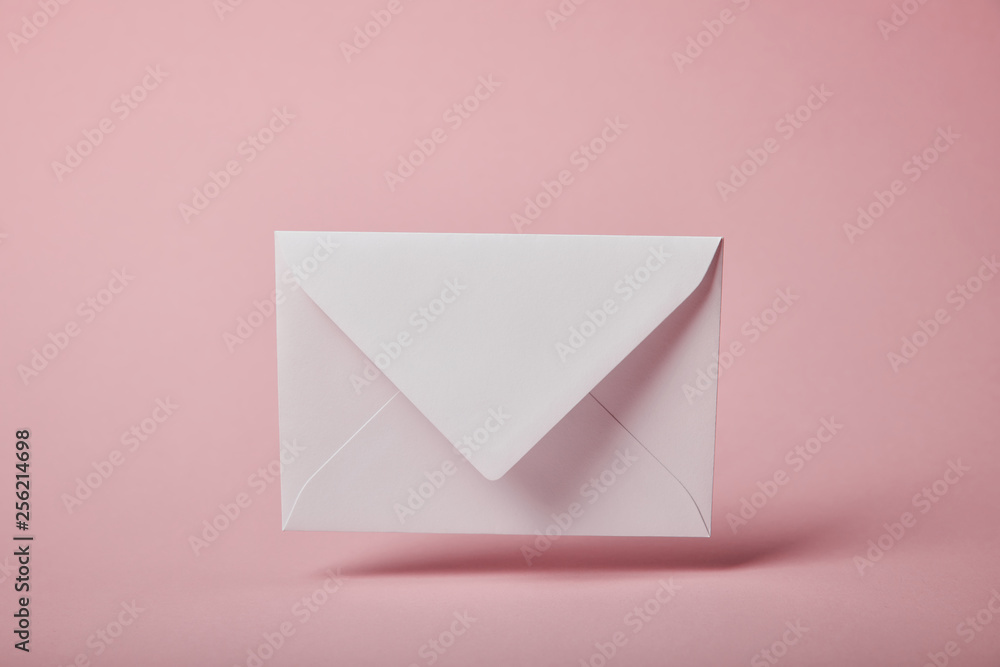 white and empty envelope on pink background with copy space white and empty envelope on pink background with copy space