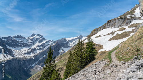 Switzerland, Beautiful scenic view on snow Alps peaks with blue sky and white clouds above © AlehAlisevich