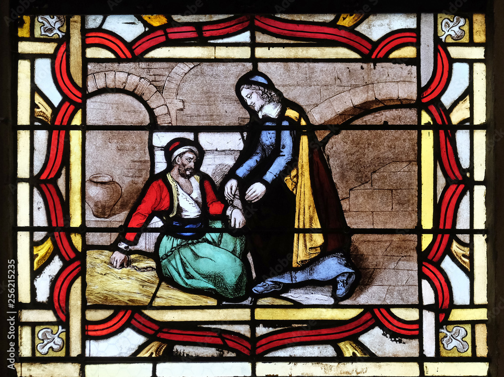 Saint Vincent de Paul helps a prisoner, stained glass window from Saint Germain-l'Auxerrois church in Paris, France