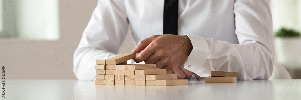 Wide view image of business executive building steps of wooden pegs Wide view image of business executive building steps of wooden pegs