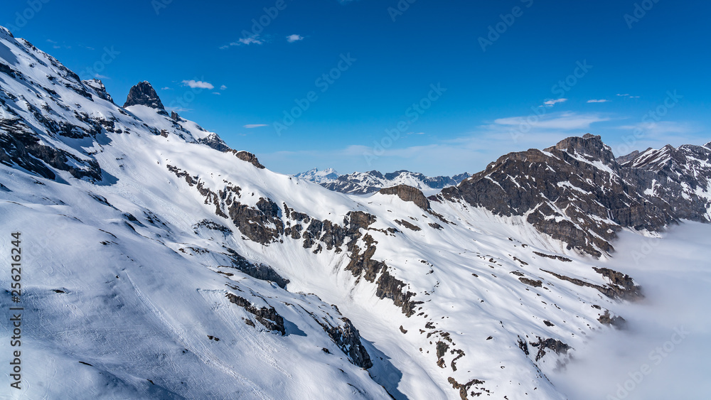 Switzerland, panorama view from Titlis mountain on Alps and mountains above white clouds Switzerland, panorama view from Titlis mountain on Alps and mountains above white clouds