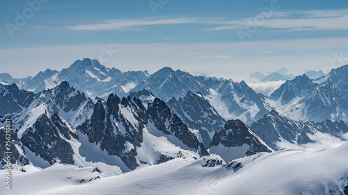 Switzerland, panorama view from Titlis mountain on Alps and mountains above white clouds