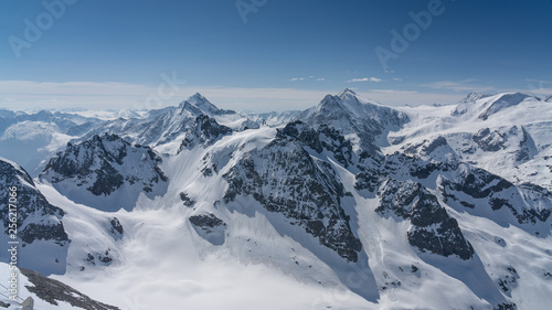 Switzerland  panorama view from Titlis mountain on Alps and mountains above white clouds