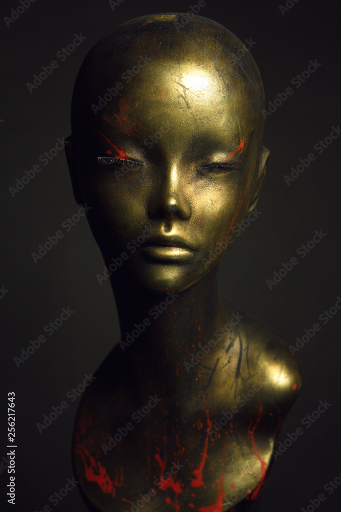 Closeup studio shot of colored woman mannequin with stylish decoration, dark background Closeup studio shot of colored woman mannequin with stylish decoration, dark background