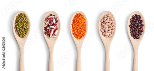 Fototapeta Naklejka Na Ścianę i Meble -  A set of wooden spoons with different beans isolated in white background. Top view.