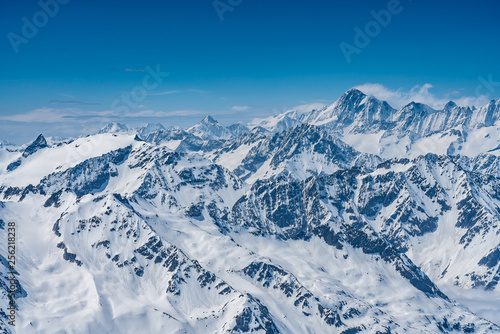 Switzerland  panorama view from Titlis mountain on Alps and mountains above white clouds